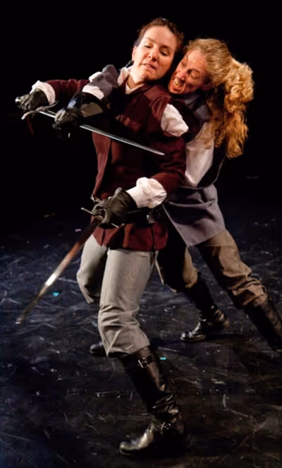 Macbeth (Kathrynne Wolf) defends herself from Macduff (Amy E. Harmon) Photo